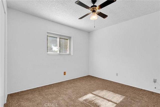 carpeted empty room featuring ceiling fan and a textured ceiling