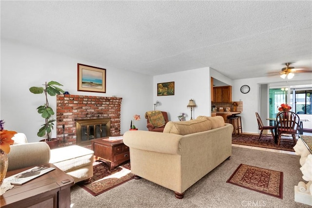 carpeted living room featuring a fireplace, a textured ceiling, and ceiling fan