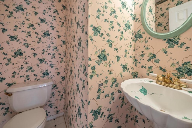 bathroom featuring sink, tile patterned floors, and toilet