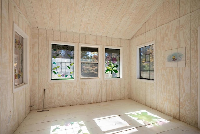 unfurnished room featuring wooden ceiling, lofted ceiling, and wood walls