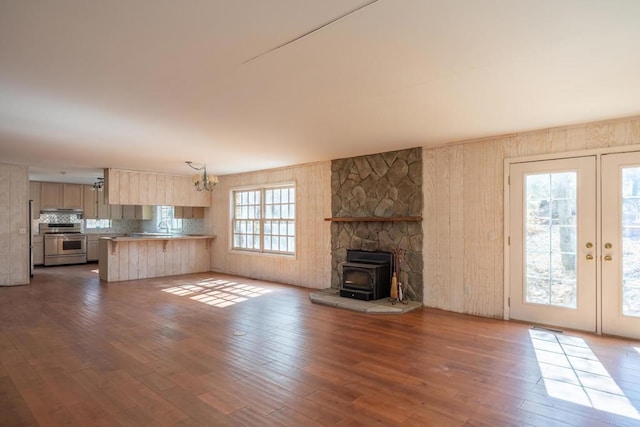 unfurnished living room with french doors, dark wood-type flooring, and sink