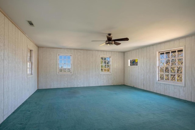 empty room featuring ceiling fan and carpet floors