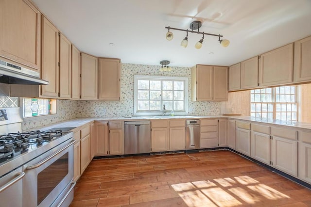 kitchen featuring light hardwood / wood-style floors, sink, light brown cabinets, and stainless steel appliances