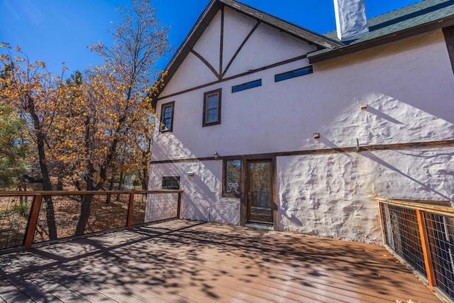 back of house featuring a wooden deck