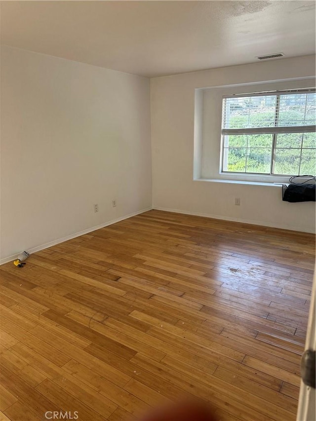 spare room featuring light hardwood / wood-style floors