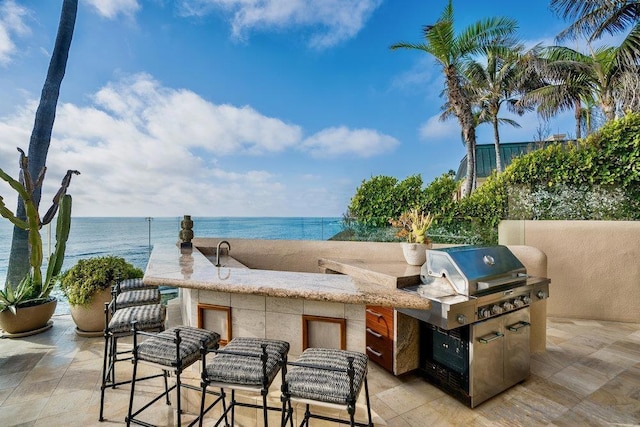 view of patio / terrace with a water view and grilling area