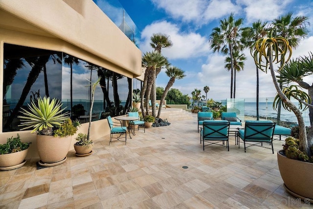 view of patio / terrace with outdoor lounge area and a water view