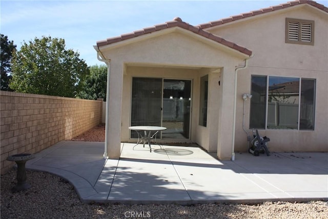 rear view of property featuring a patio