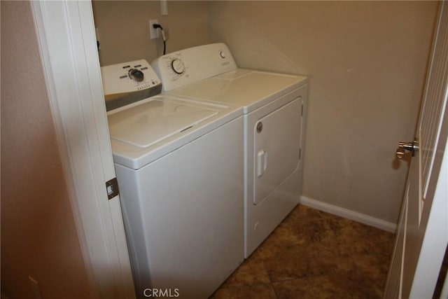 laundry area with tile patterned floors and separate washer and dryer