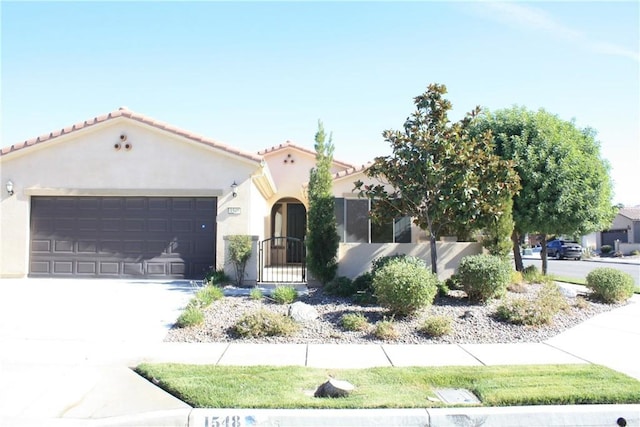 mediterranean / spanish home featuring a garage