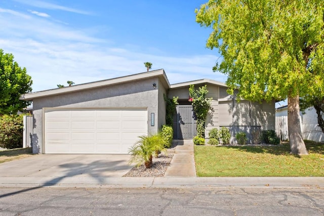 view of front of house with a garage and a front lawn