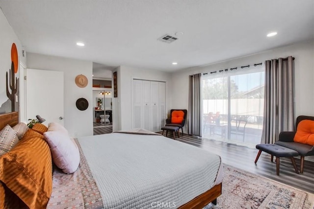 bedroom featuring access to exterior, hardwood / wood-style flooring, and a closet