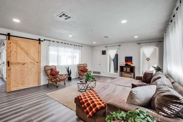 living room featuring hardwood / wood-style floors and a barn door