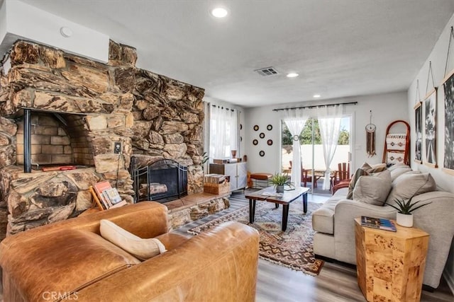 living room with a fireplace and light hardwood / wood-style flooring