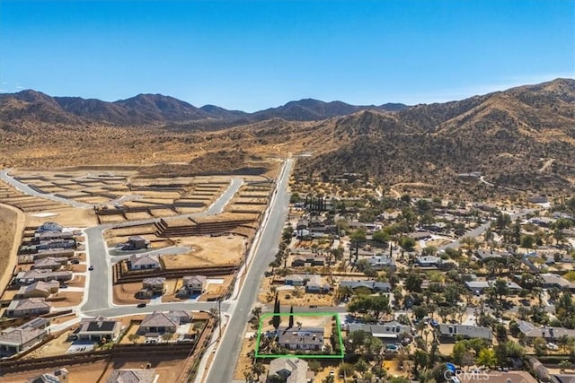 birds eye view of property featuring a mountain view