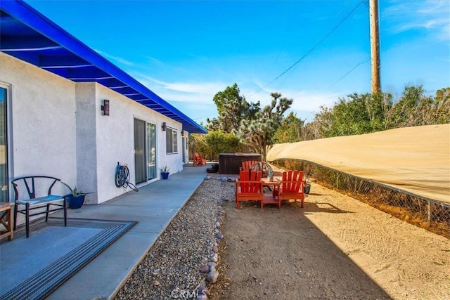 view of yard featuring a jacuzzi and a patio