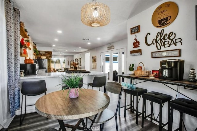 dining space featuring dark hardwood / wood-style floors, a healthy amount of sunlight, and french doors