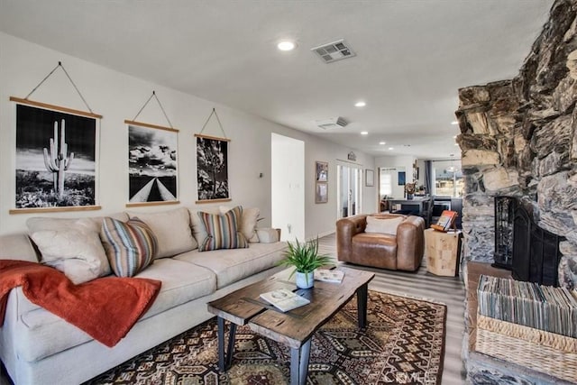 living room with wood-type flooring and a fireplace