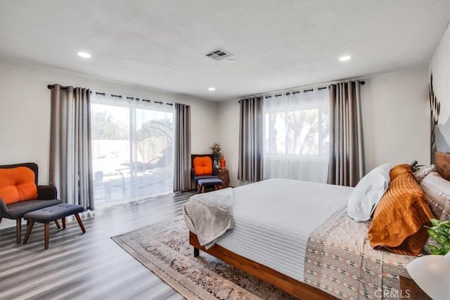 bedroom featuring access to exterior and wood-type flooring