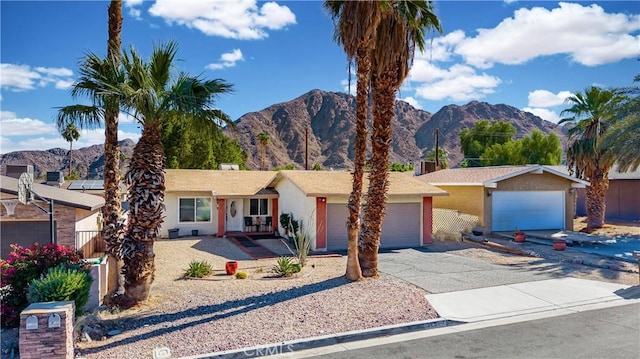 single story home with a mountain view and a garage