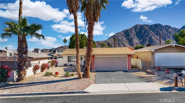 single story home featuring a garage and a mountain view