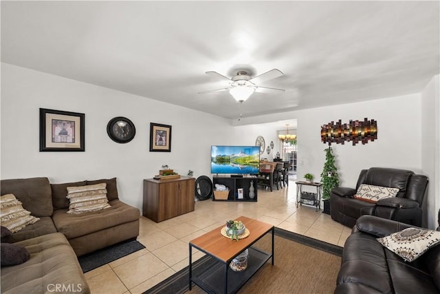 living room featuring ceiling fan with notable chandelier and light tile patterned floors