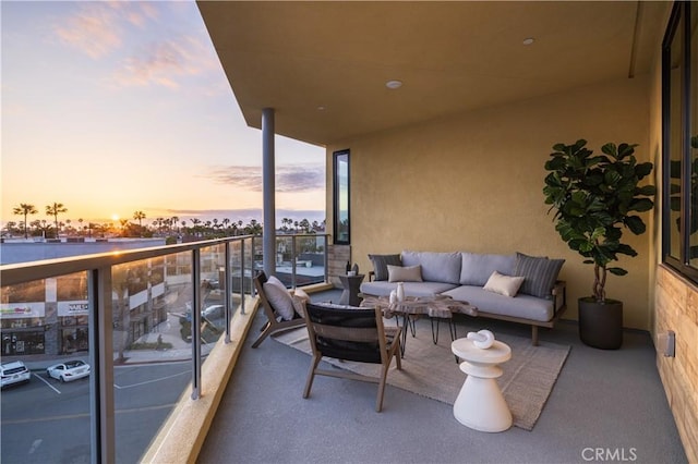 balcony at dusk with an outdoor living space