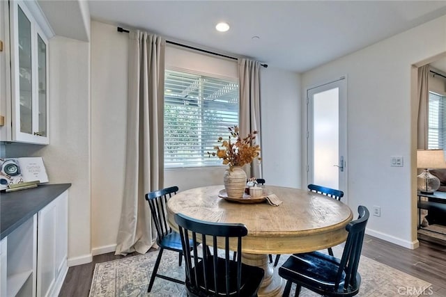 dining room with dark hardwood / wood-style flooring