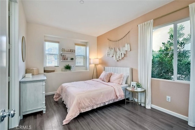 bedroom featuring multiple windows and dark wood-type flooring