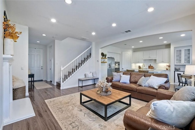 living room with sink and dark hardwood / wood-style flooring