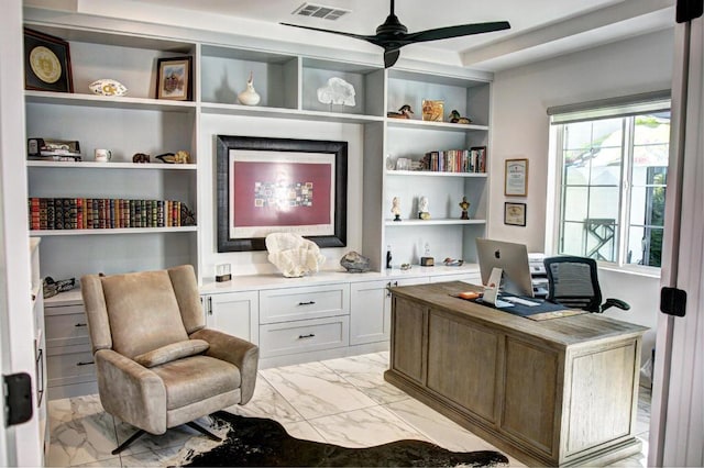 office area featuring ceiling fan, built in desk, and built in shelves