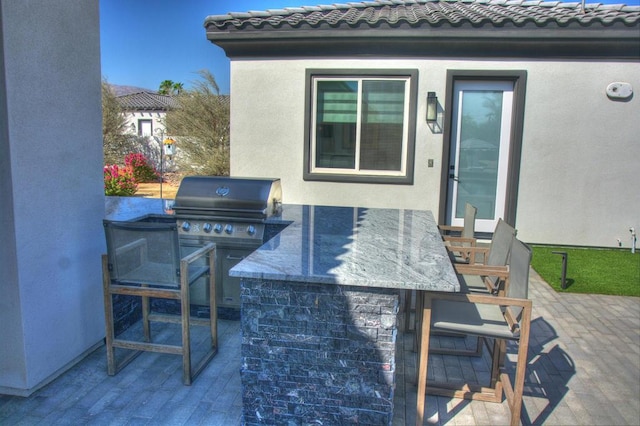 view of patio / terrace with grilling area and a bar