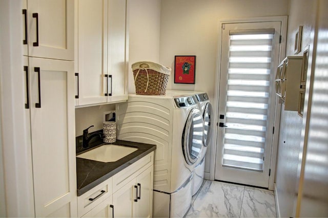 washroom featuring cabinets, washer and clothes dryer, and sink