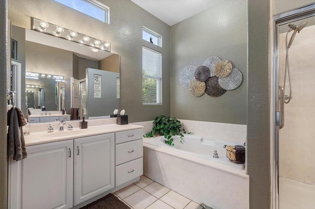 bathroom featuring shower with separate bathtub, vanity, and tile patterned floors