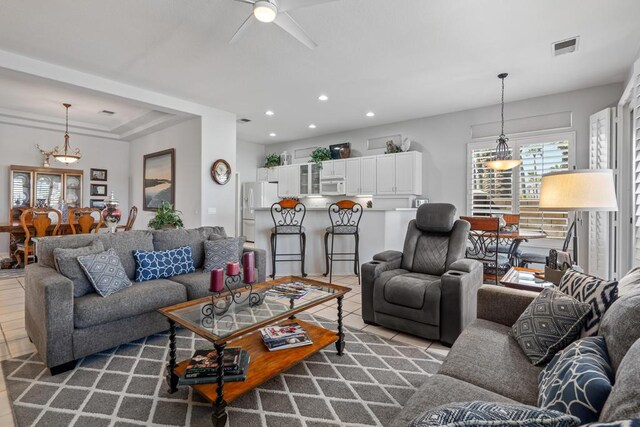 living room featuring ceiling fan and light tile patterned floors