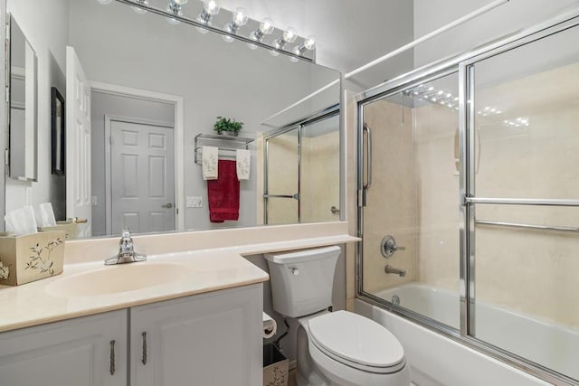 full bathroom with toilet, combined bath / shower with glass door, and vanity