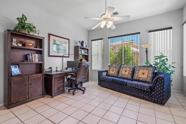 tiled office featuring ceiling fan