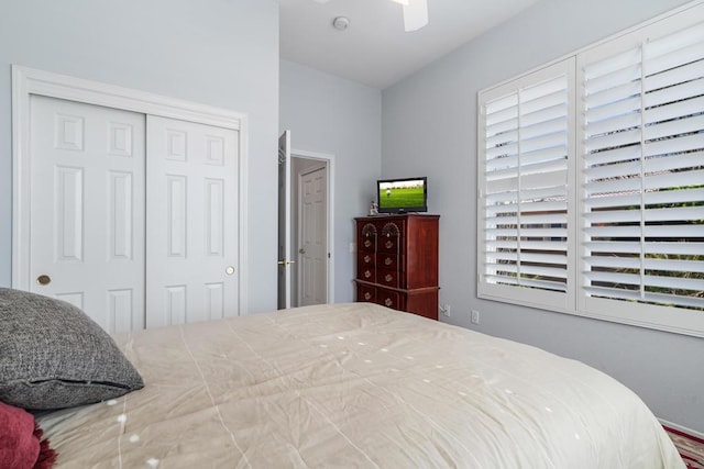 bedroom with ceiling fan and a closet