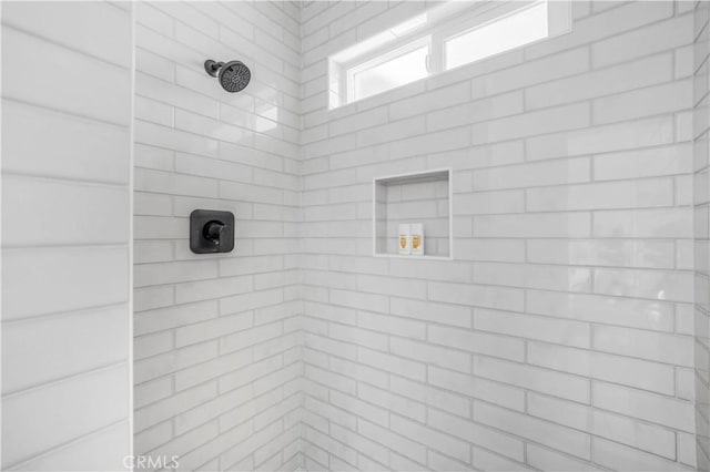 bathroom with a tile shower