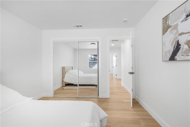 bedroom with a closet and light wood-type flooring