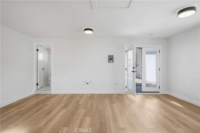 spare room with light hardwood / wood-style flooring