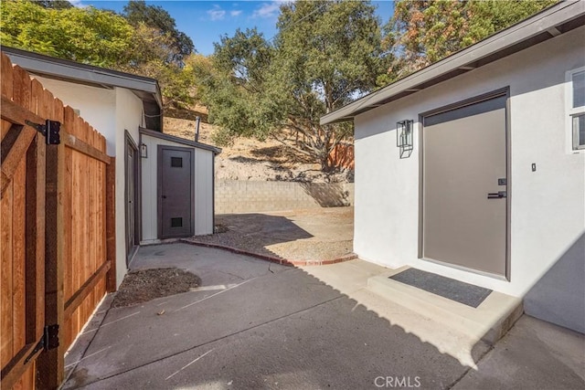 view of patio featuring a storage unit