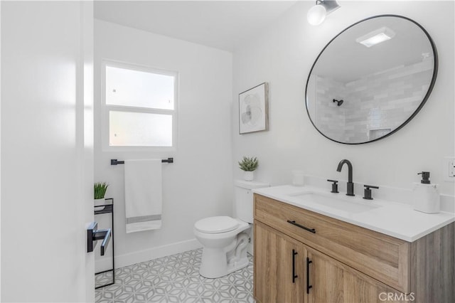 bathroom featuring tile patterned floors, vanity, and toilet