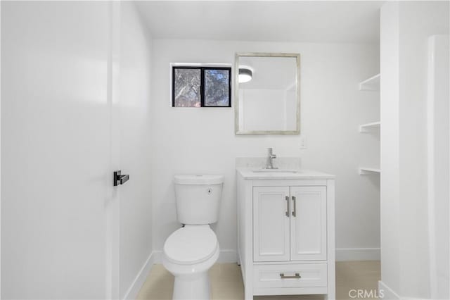 bathroom with tile patterned floors, vanity, and toilet