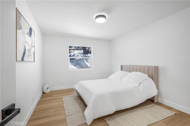 bedroom with wood-type flooring