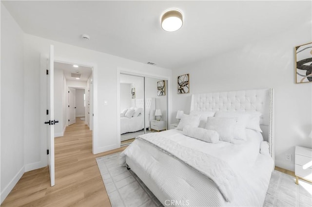 bedroom featuring hardwood / wood-style flooring and a closet