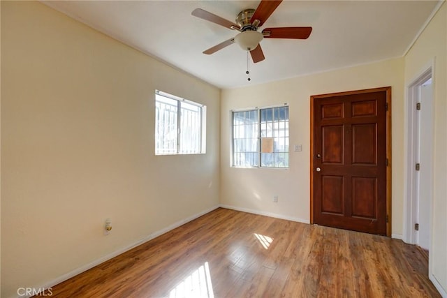 foyer with ceiling fan and wood-type flooring