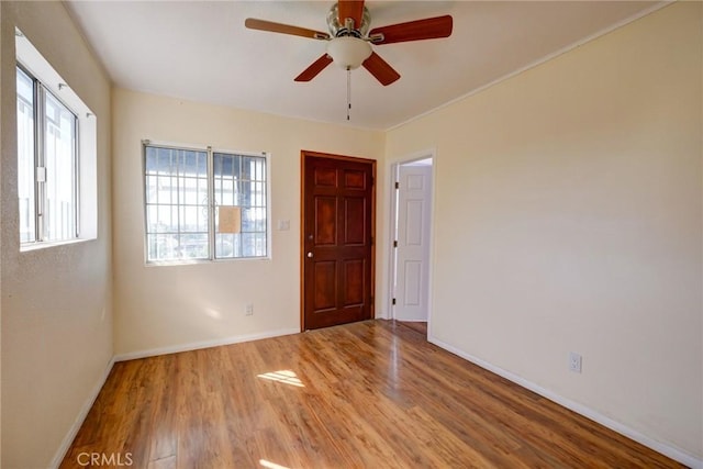 spare room featuring light hardwood / wood-style floors and ceiling fan