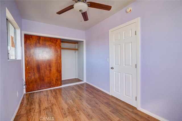 unfurnished bedroom featuring wood-type flooring, a closet, and ceiling fan