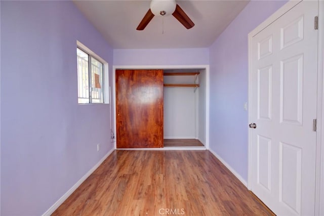 unfurnished bedroom featuring ceiling fan, wood-type flooring, and a closet